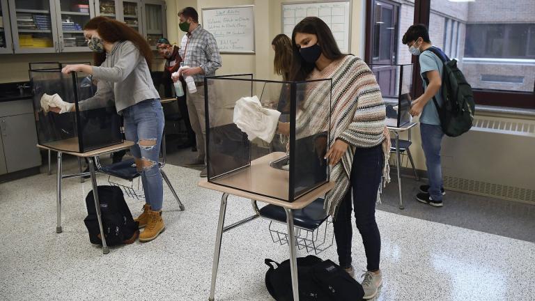 In this March 18, 2021, file photo, students in teacher Christopher Duggan's science class clean their work areas at the end of class at Windsor Locks High School in Windsor Locks, Conn. (AP Photo/Jessica Hill, File) In this March 18, 2021, file photo, students in teacher Christopher Duggan's science class clean their work areas at the end of class at Windsor Locks High School in Windsor Locks, Conn. (AP Photo/Jessica Hill, File)