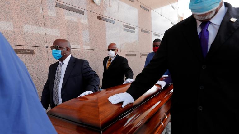 In this April 22, 2020, file photo, pallbearers, who were among only 10 allowed mourners, walk the casket for internment at the funeral for Larry Hammond, who died from the coronavirus, at Mount Olivet Cemetery in New Orleans. (AP Photo / Gerald Herbert, File)