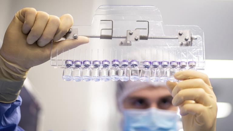 In this March 2021 photo provided by Pfizer, a technician inspects filled vials of the Pfizer-BioNTech COVID-19 vaccine at the company’s facility in Puurs, Belgium. (Pfizer via AP)