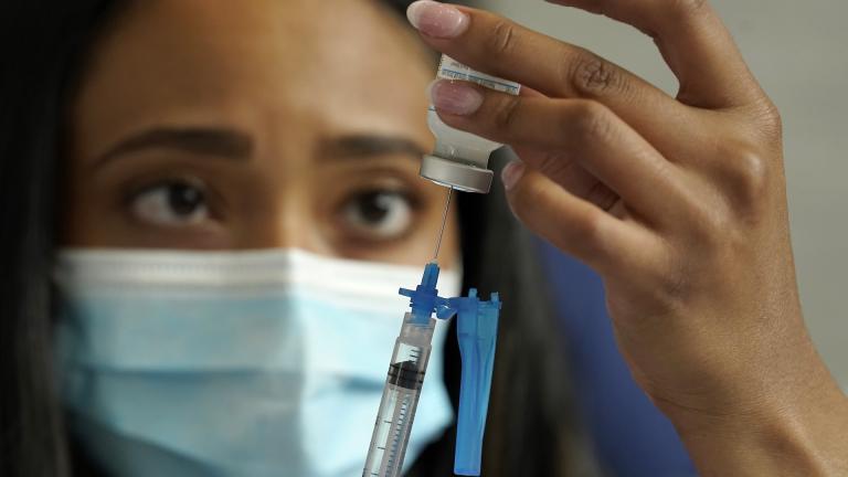 In this May 19, 2021, file photo, a licensed practical nurse draws a Moderna COVID-19 vaccine into a syringe at a mass vaccination clinic at Gillette Stadium in Foxborough, Mass. (AP Photo/Steven Senne, File)