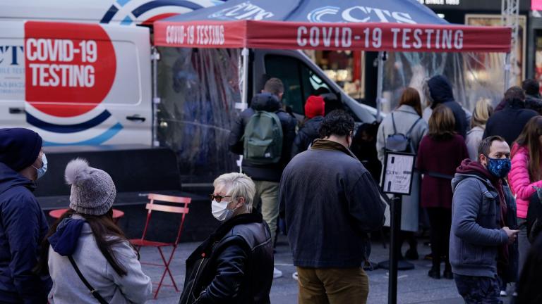 People wait in line at a COVID-19 testing site in Times Square, New York, Dec. 13, 2021. (AP Photo / Seth Wenig, File)