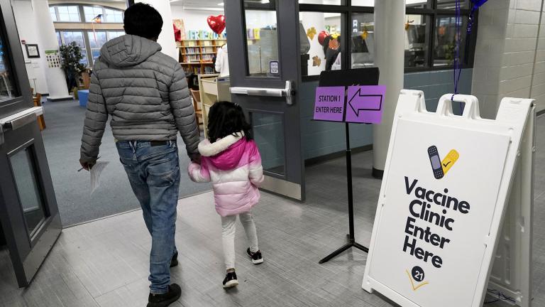 A child arrives with her parent to receive the Pfizer COVID-19 vaccine for children 5 to 11-years-old at London Middle School in Wheeling, Ill., Nov. 17, 2021. (AP Photo / Nam Y. Huh, File)