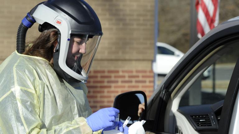 Nurse Jordan Ledbetter performs a test for COVID-19 outside the Marion County Health Department in Hamilton, Alabama, on Tuesday, Feb. 15, 2022. (AP Photo / Jay Reeves)