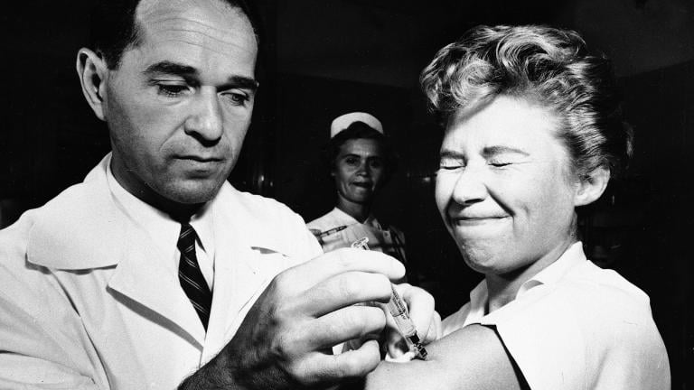 Dr. Joseph Ballinger giving Marjorie Hill, a nurse at Montefiore Hospital in New York, the first Asian flu vaccine shot to be administered in New York on Aug. 16, 1957. (AP Photo / File)
