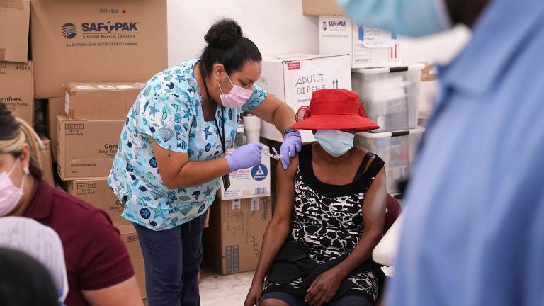 In this April 10, 2021, file photo, registered nurse Ashleigh Velasco, left, administers the Johnson & Johnson COVID-19 vaccine to Rosemene Lordeus, right, at a clinic held by Healthcare Network in Immokalee, Fla. (AP Photo / Lynne Sladky, File)