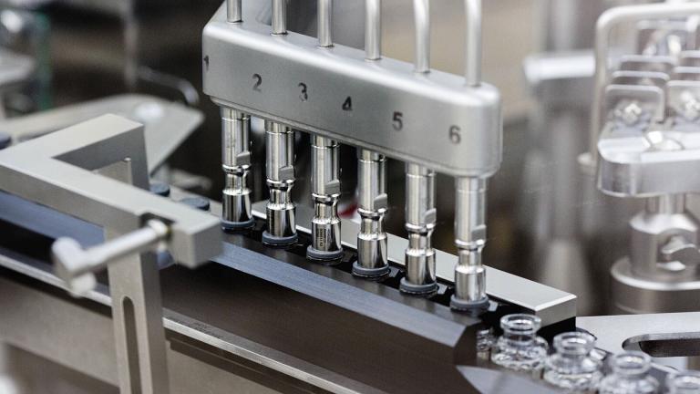 In this March 2020 photo provided by Gilead Sciences, rubber stoppers are placed onto filled vials of the investigational drug remdesivir at a Gilead manufacturing site in the United States. (Gilead Sciences via AP)