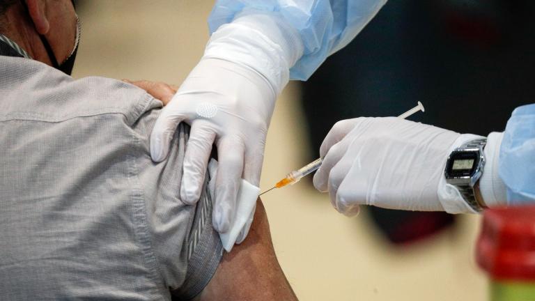 In this Friday, March 19, 2021 file photo Medical staff members administer the AstraZeneca vaccine at La Nuvola (The Cloud) convention center that was temporarily turned into a COVID-19 vaccination hub, in Rome. (AP Photo / Gregorio Borgia)