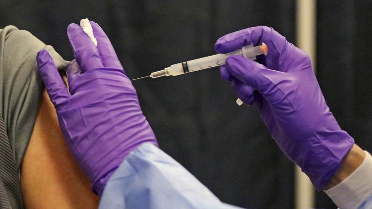 A man gets a COVID-19 vaccine at a mass vaccination site at the Natick Mall on Wednesday, Feb. 24, 2021, in Natick, Mass. (Matt Stone / The Boston Herald via AP, Pool)