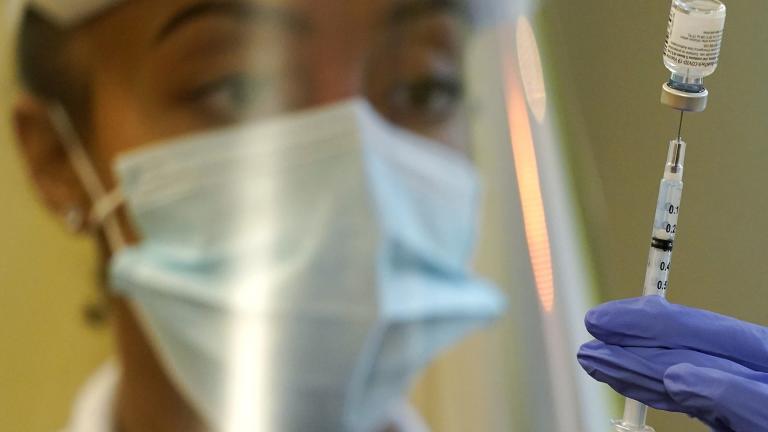 In this Jan. 8, 2021, file photo, a pharmacist prepares a syringe of the Pfizer vaccine for COVID-19, at Queen Anne Healthcare, a skilled nursing and rehabilitation facility in Seattle. (AP Photo / Ted S. Warren, File)