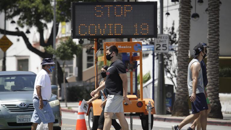 Pedestrians wear masks as they cross a street amid the coronavirus pandemic Sunday, July 12, 2020, in Santa Monica, Calif. (AP Photo / Marcio Jose Sanchez)