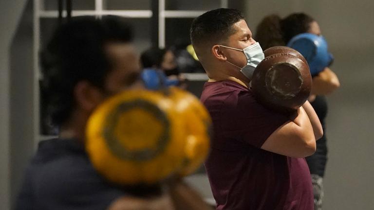 In this Nov. 24, 2020, file photo, Juan Avellan, center, and others wear masks while working out in an indoor class at a Hit Fit SF gym amid the coronavirus outbreak in San Francisco. (AP Photo / Jeff Chiu, File) In this Nov. 24, 2020, file photo, Juan Avellan, center, and others wear masks while working out in an indoor class at a Hit Fit SF gym amid the coronavirus outbreak in San Francisco. (AP Photo / Jeff Chiu, File)