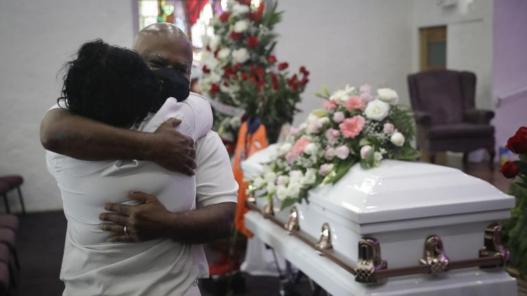 In this July 21, 2020, file photo, Darryl Hutchinson, facing camera, is hugged by a relative during a funeral service for Lydia Nunez, who was Hutchinson’s cousin at the Metropolitan Baptist Church in Los Angeles. Nunez died from COVID-19. (AP Photo / Marcio Jose Sanchez, File)