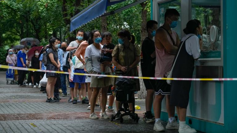 Residents wearing face masks wait in line to get their routine COVID-19 throat swabs at a coronavirus testing site in Beijing, Tuesday, Aug. 9, 2022. Chinese authorities have closed Tibet’s famed Potala Palace after a minor outbreak of COVID-19 was reported in the Himalayan region. (AP Photo / Andy Wong)