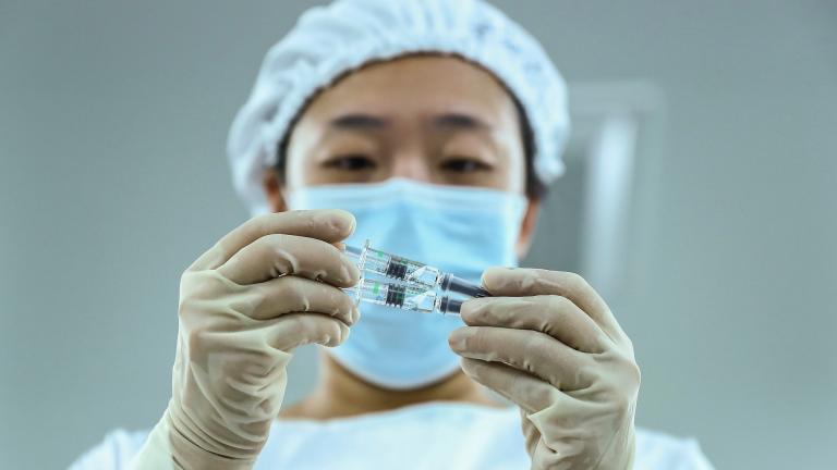 In this Dec. 25, 2020 file photo, released by Xinhua News Agency, a staff member inspects syringes of COVID-19 inactivated vaccine products at a packaging plant of the Beijing Biological Products Institute Co., Ltd, a unit of state-owned Sinopharm in Beijing. (Zhang Yuwei / Xinhua via AP, File)