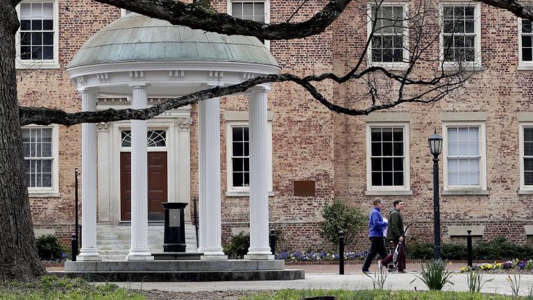 In this Wednesday, March 18, 2020, file photo, people remove belongings on campus at the University of North Carolina in Chapel Hill, N.C., amid the coronavirus pandemic. (AP Photo / Gerry Broome, File)