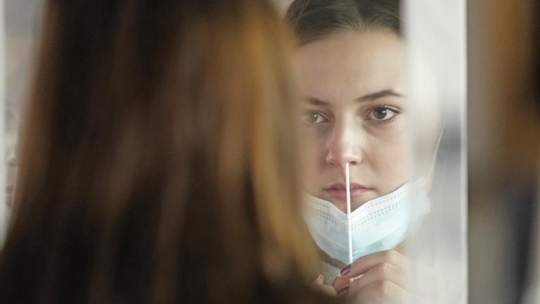 In this Nov. 18, 2020, file photo, University of Utah student Abigail Shull takes a rapid COVID-19 test in Salt Lake City. (AP Photo/Rick Bowmer, File) In this Nov. 18, 2020, file photo, University of Utah student Abigail Shull takes a rapid COVID-19 test in Salt Lake City. (AP Photo/Rick Bowmer, File)