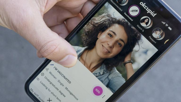 A sample page on the OkCupid app is held for a photograph showing the "I'm vaccinated," checkmark, Friday, May 21, 2021, in Washington. (AP Photo / Alex Brandon)