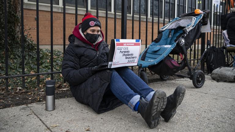 In this Jan. 11, 2021 file photo, a Suder Montessori Magnet Elementary School teacher speaks to students during a virtual class outside of the school in solidarity with pre-K educators forced back into the building in Chicago. (Anthony Vazquez / Chicago Sun-Times via AP, File)