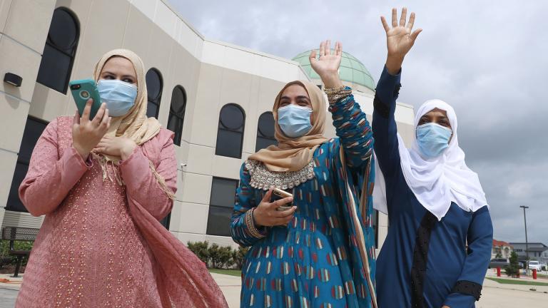 Saba Mahjabeen, right, and Gizman Mawi, center, waive as Sophia Baig looks on during a drive through Eid al-Fitr celebration outside a closed mosque in Plano, Texas, Sunday, May 24, 2020. (AP Photo / LM Otero)