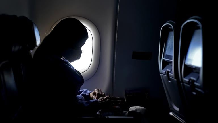 In this Wednesday, Feb. 3, 2021, file photo, a passenger wears a face mask she travels on a flight from Hartsfield-Jackson International Airport in Atlanta. (AP Photo / Charlie Riedel, File)