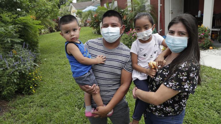 In this Sunday, June 7, 2020, photo, Elbin Sales, second from left, poses for a photograph with his wife, Yecenia Solorzano, right, and children Jordi Sales, left, and Athena Sales, amid the new coronavirus pandemic in Immokalee, Fla. (AP Photo / Lynne Sladky)