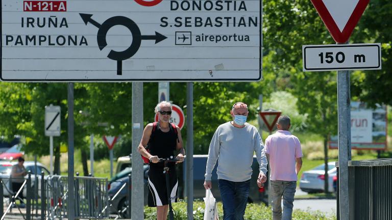 People cross the border between France and Spain at Behobie, southwestern France, Sunday, June 21, 2020. Spain reopened its borders to European tourists Sunday in a bid to kickstart its economy while Brazil and South Africa struggled with rising coronavirus infections. (AP Photo / Bob Edme)