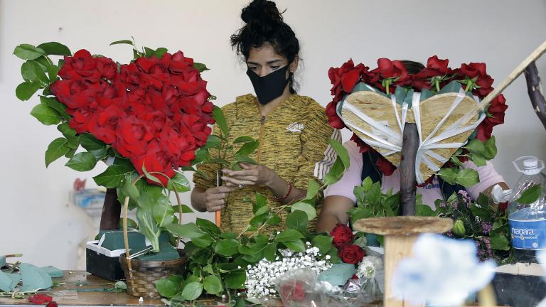 In this May 10, 2020, file photo, a merchant prepares a floral arrangement on Mother’s Day at the Los Angeles Flower Market in Los Angeles. (AP Photo / Marcio Jose Sanchez, File) In this May 10, 2020, file photo, a merchant prepares a floral arrangement on Mother’s Day at the Los Angeles Flower Market in Los Angeles. (AP Photo / Marcio Jose Sanchez, File)