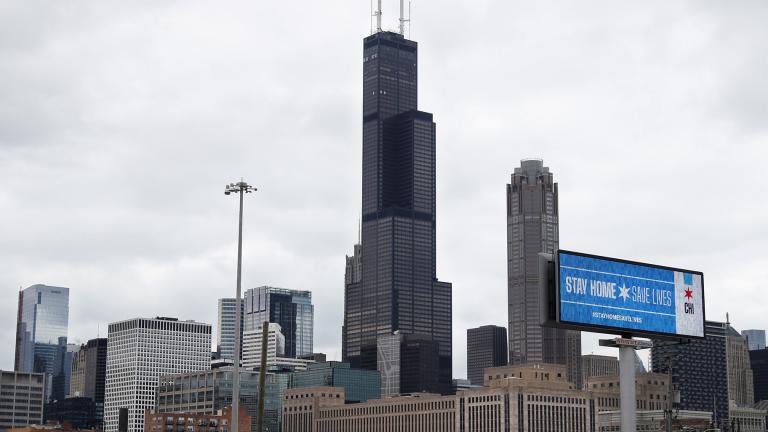 A public service message reading Stay Home Saves Lives is seen against the Chicago skyline Monday, March 30, 2020. (AP Photo/ Charles Rex Arbogast)