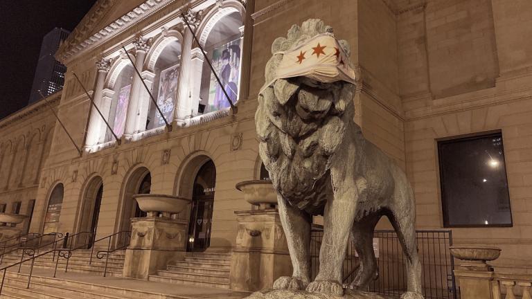 This Friday, May 1, 2020 photo shows a lion statue with a mask placed on it at the Art Institute of Chicago. (Sam Kelly / Chicago Sun-Times via AP)