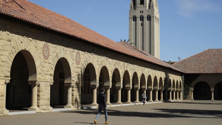 In this March 14, 2019, file photo, people walk on the Stanford University campus beneath Hoover Tower in Stanford, Calif. (AP Photo / Ben Margot, File)