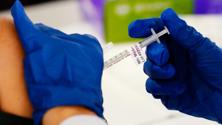 A health worker administers a dose of a Moderna COVID-19 vaccine during a vaccination clinic at the Norristown Public Health Center in Norristown, Pa., Tuesday, Dec. 7, 2021. (AP Photo / Matt Rourke, File)