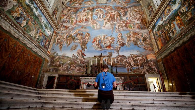 A visitor kneels in front of the Last Judgement fresco by the Italian Renaissance painter Michelangelo inside the Sistine Chapel of the Vatican Museums on the occasion of the museum's reopening, in Rome, Monday, May 3, 2021. The Vatican Museums reopened Monday to visitors after a shutdown following COVID-19 containment measures. (AP Photo / Alessandra Tarantino)
