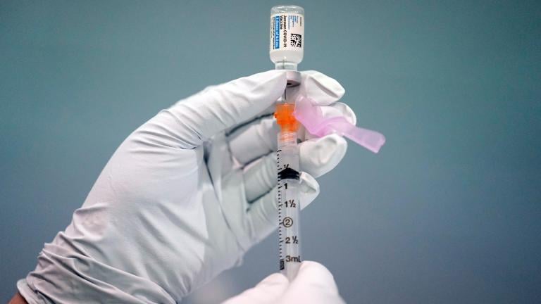 A member of the Philadelphia Fire Department prepares a dose of the Johnson & Johnson COVID-19 vaccine at a vaccination site setup in Philadelphia, on March 26, 2021. (AP Photo / Matt Rourke, File)