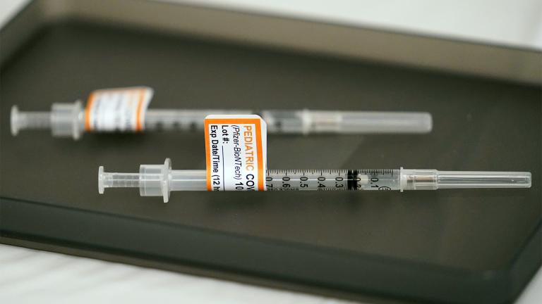 Prepared Pfizer COVID-19 vaccine syringes for children ages 5 to 11 and adults are displayed on a table at Northwest Community Church in Chicago, Dec. 11, 2021.  (AP Photo / Nam Y. Huh, File) 