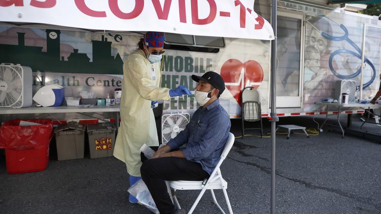 Nurse Tanya Markos administers a coronavirus test on patient Ricardo Sojuel at a mobile COVID-19 testing unit, Thursday, July 2, 2020, in Lawrence, Mass. (AP Photo / Elise Amendola)