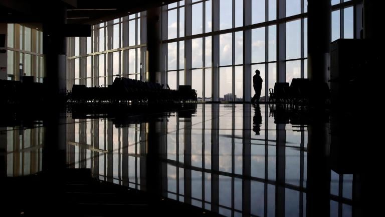 In this Monday, June 1, 2020 file photo, a woman looks through a window at a near-empty terminal at an airport in Atlanta. (AP Photo / Charlie Riedel) In this Monday, June 1, 2020 file photo, a woman looks through a window at a near-empty terminal at an airport in Atlanta. (AP Photo / Charlie Riedel)