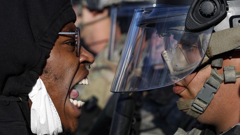Protesters and National Guardsmen face off on East Lake Street, Friday, May 29, 2020, in St. Paul, Minn. (AP Photo / John Minchillo)