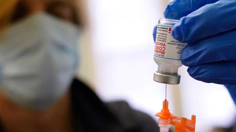 Pharmacist Kenni Clark prepares a booster dose of the Moderna COVID-19 vaccine during a vaccination clinic at City of Lawrence’s “The Center,” which serves seniors, families and the community, Wednesday, Dec. 29, 2021, in Lawrence, Mass. (AP Photo / Charles Krupa, File)