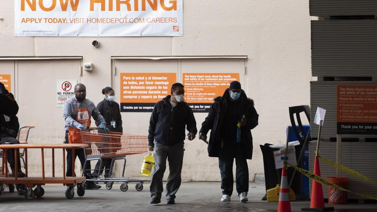 Home Depot customers carry their purchases as they leave the store, Friday, April 3, 2020 during the coronavirus pandemic in New York. (AP Photo / Mark Lennihan)