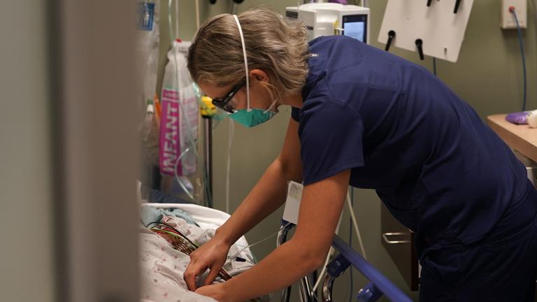 Registered nurse Sandra Younan adjusts an intravenous line for a patient at the emergency room of Providence Cedars-Sinai Tarzana Medical Center in the Tarzana neighborhood of Los Angeles on Thursday, March 11, 2021. (AP Photo / Damian Dovarganes)
