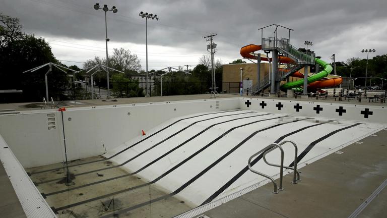 In this photo taken Friday, May 15, 2020, the public pool in Mission, Kan. is lifeless as plans remain in place to keep the pool closed for the summer to help prevent the spread of COVID-19. (AP Photo / Charlie Riedel)