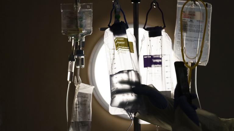 Nurse manager Edgar Ramirez checks on IV fluids while talking to a COVID-19 patient at Providence Holy Cross Medical Center in Los Angeles, Dec. 13, 2021. (AP Photo / Jae C. Hong, File)