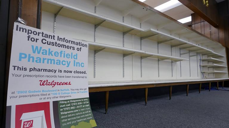 A sign informing customers that the pharmacy is closed sits in an empty store in Wakefield, Va., Tuesday, Feb. 9, 2021. Getting the coronavirus vaccine has been a challenge for rural counties in the U.S. that lack medical facilities such as a pharmacy or a well-equipped doctor's office. (AP Photo / Steve Helber)