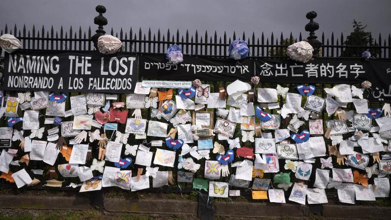 In this Thursday, May 28, 2020 file photo, a fence outside Brooklyn’s Green-Wood Cemetery is adorned with tributes to victims of COVID-19 in New York. (AP Photo / Mark Lennihan)