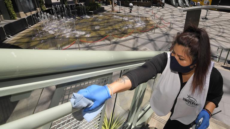 In this Thursday, June 11, 2020 file photo, Andrea Castaneda cleans the railings at Universal CityWalk near Universal City, California. (AP Photo / Mark J. Terrill)