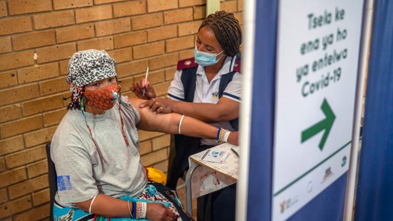 An Orange Farm, South Africa, resident receives her jab against COVID-19 Friday Dec. 3, 2021 at the Orange Farm multipurpose center. South Africa has accelerated its vaccination campaign a week after the discovery of the omicron variant of the coronavirus. (AP Photo / Jerome Delay)