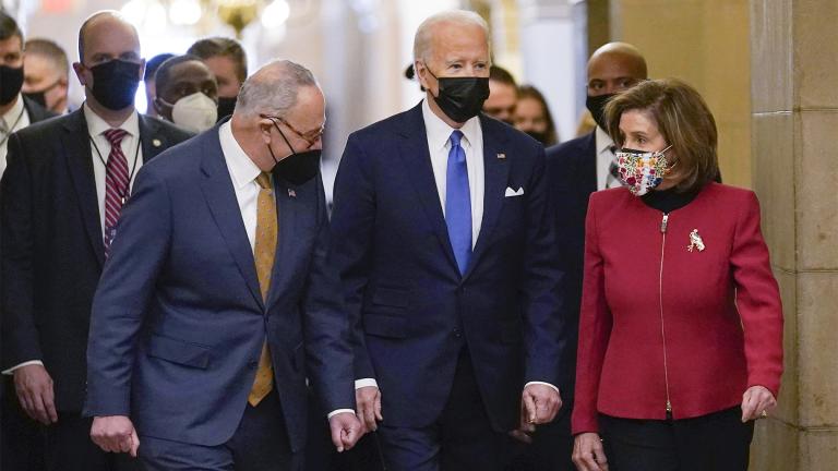 President Joe Biden is flanked by Senate Majority Leader Chuck Schumer of N.Y., left, and House Speaker Nancy Pelosi of Calif., right, after arriving on Capitol Hill in Washington, Jan. 6, 2022. AP Photo / Susan Walsh, File)