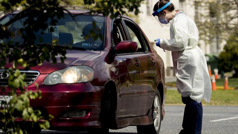 A medical worker prepares to test a young man for COVID-19 at a Children's National Hospital drive-through coronavirus testing site at Trinity University, Thursday, April 16, 2020, in Washington. (AP Photo / Andrew Harnik)