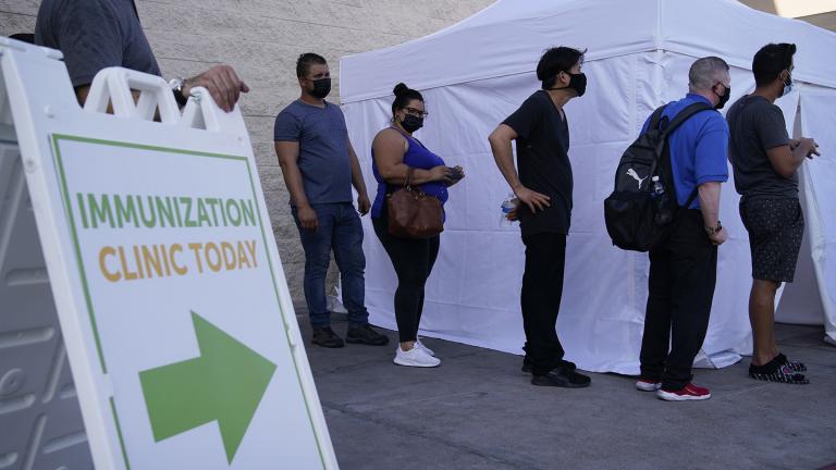 In this Wednesday, July 7, 2021, file photo, people wait in line for COVID-19 vaccinations at an event at La Bonita market, a Hispanic grocery store, in Las Vegas. (AP Photo / John Locher, File)