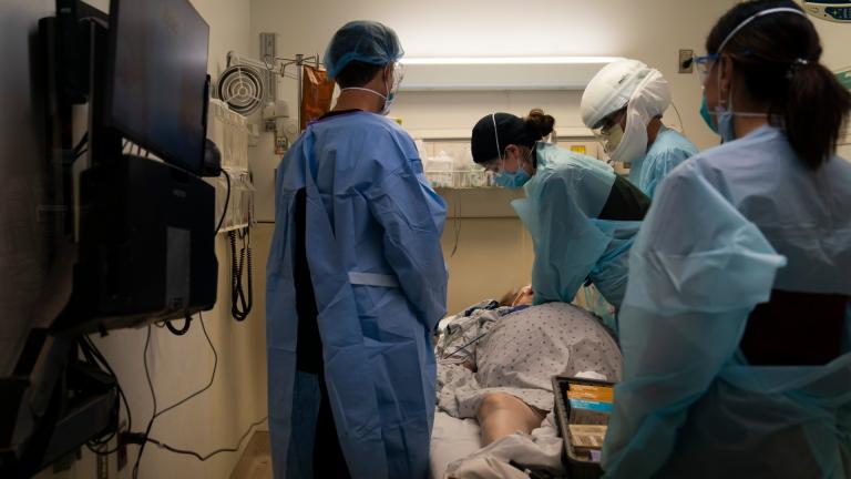 In this Nov. 19, 2020, file photo, EMT Giselle Dorgalli, third from right, performs chest compression on a patient who tested positive for coronavirus in the emergency room at Providence Holy Cross Medical Center in the Mission Hills section of Los Angeles. (AP Photo / Jae C. Hong, File)